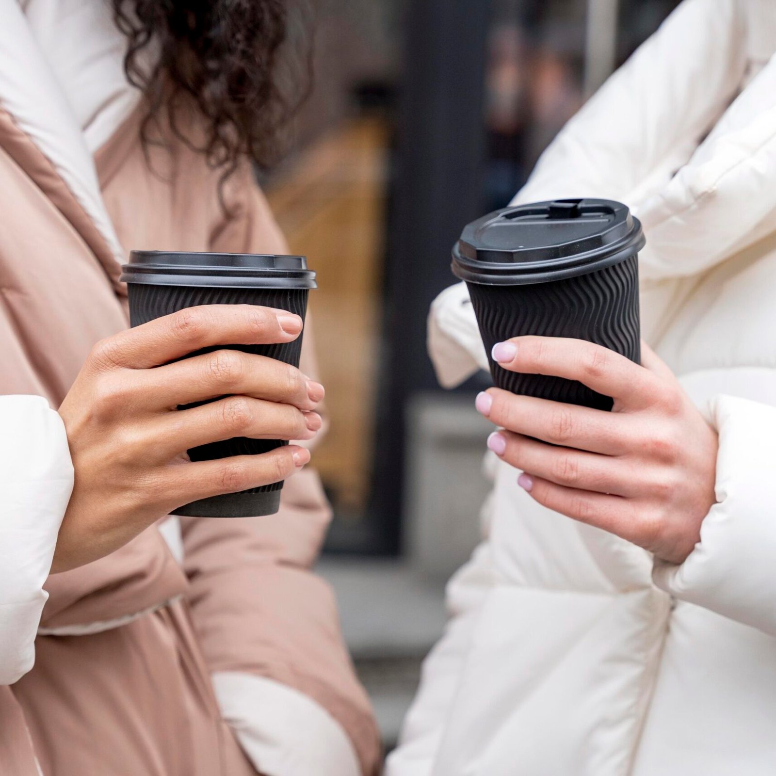 close-up-hands-holding-coffee-cups